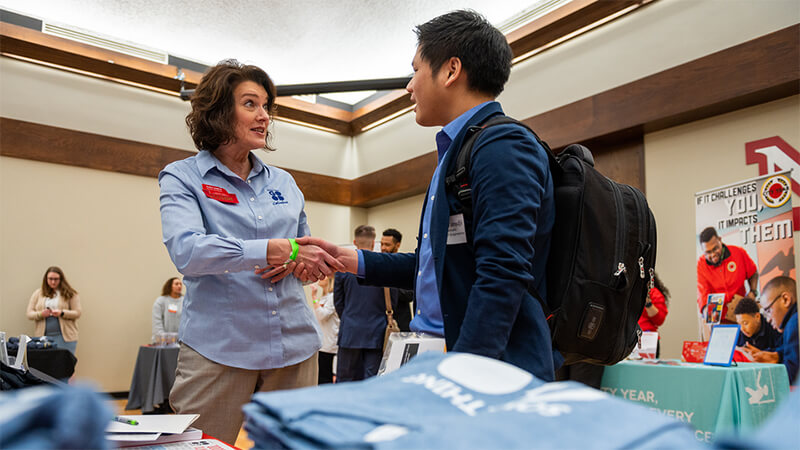 Students mingling with prospective employers.