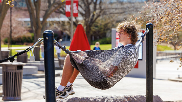 Matt Fischer sits on a hammock outside the city campus Union on the Monday post Spring Break.