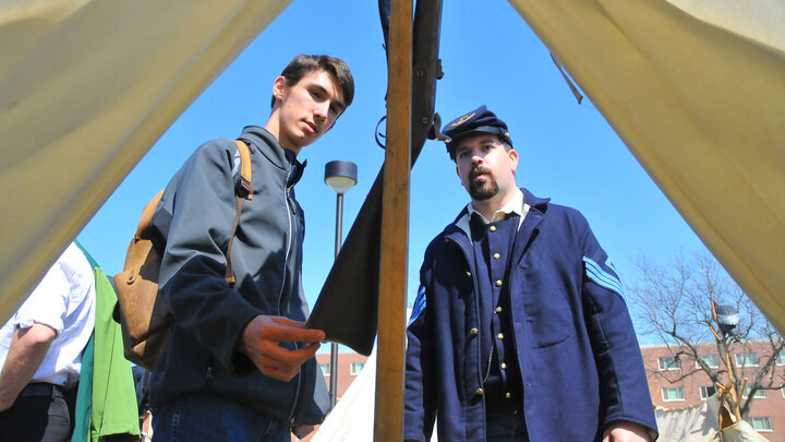 Braeden Perrie, a sophomore history and electrical engineering major from Minden, Neb., talks with Civil War re-enactor Joshua Andersen. The Shiloh Camp No. 2 division of the Sons of Union Veterans of the Civil War set up camp north of the Nebraska Union and interacted with students, faculty and staff on April 17.